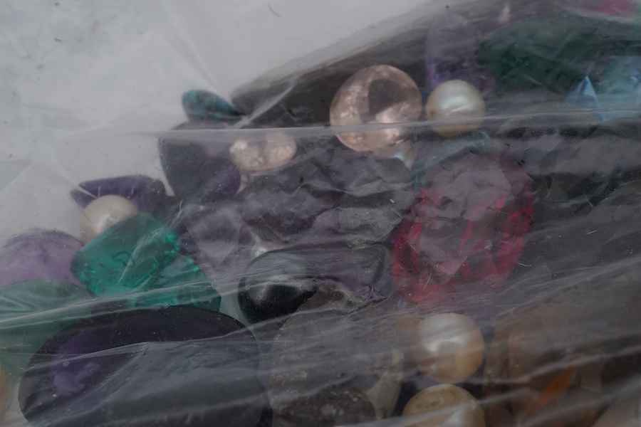 A bag of loose stones, including amethysts, garnets, cultured pearls, a quantity of small diamonds and rubies, jadeite beads, a green chrysoprase intaglio depicting the cathedral of St Stephen, Vienna, and various synthe